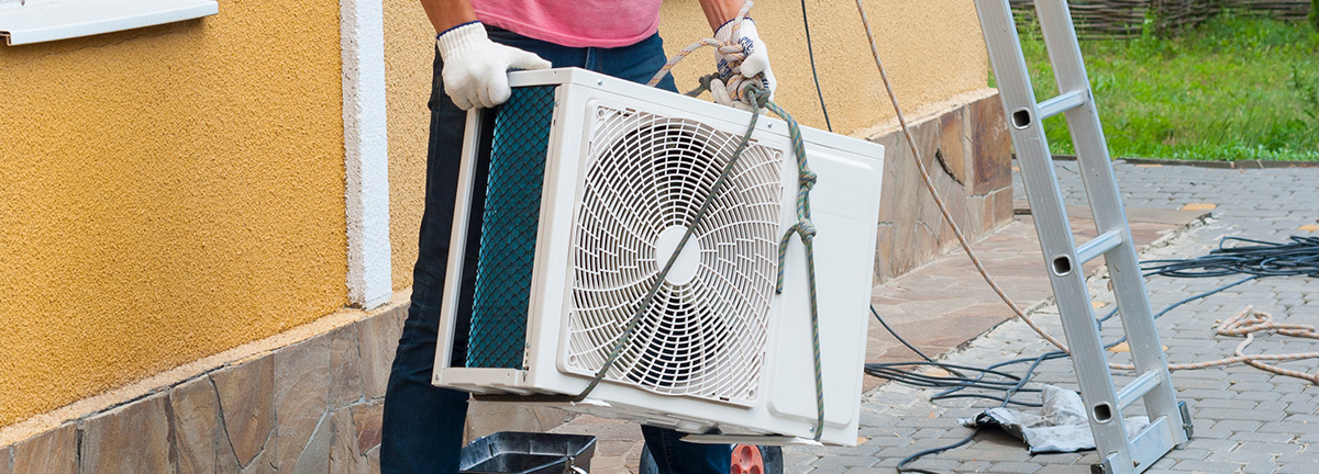 an outdoor air conditioning unit being installed.